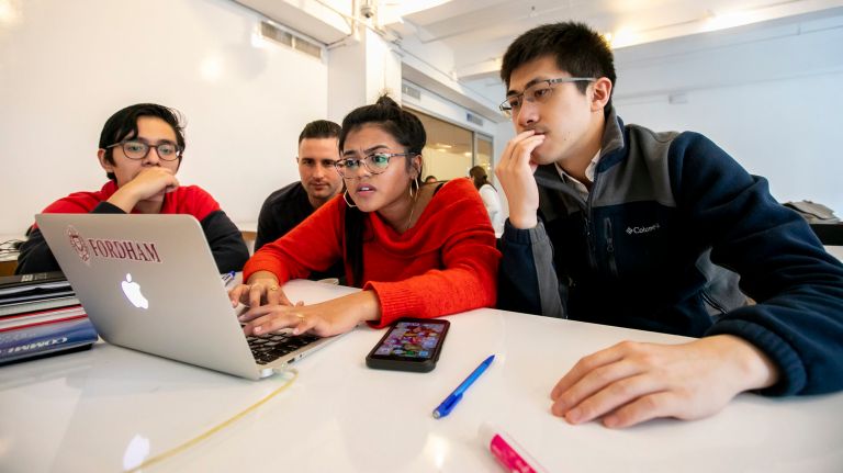 From left: Project Destined participant&nbsp;Eduardo Iriarte Ibanez, 15, of the Bronx,&nbsp;Mark Gaudette, a mentor who works at Brookfield,&nbsp;Anisha Pednekar, 21, of the Bronx, and Robert Li, a mentor who works at Brookfield, focus on a slide presentation.&nbsp;