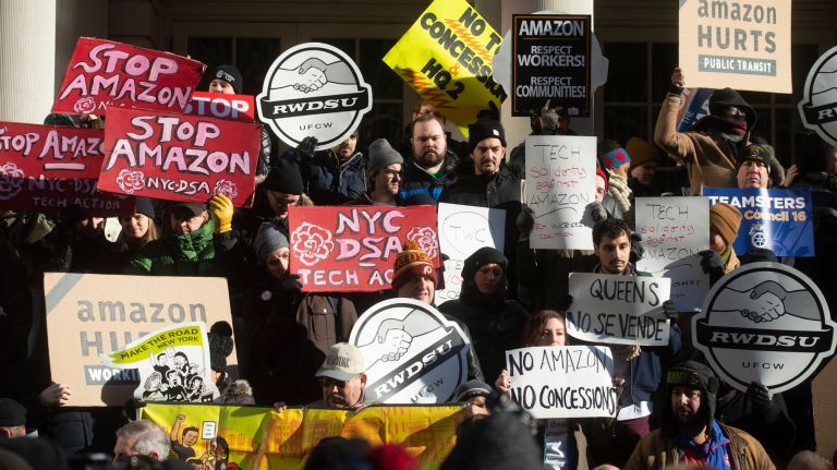 Union groups protest the deal on the steps of City Hall on Wednesday.