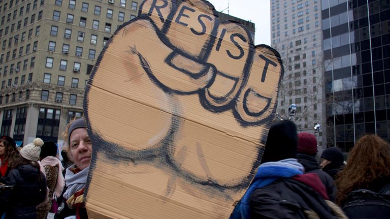 Katt Lissard, who attended the Women's Unity Rally in Foley Square, said she's been using the same "Resistance" poster for years.