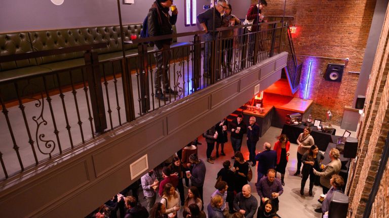 A second floor bar with a balcony at the Nighthawk Prospect Park.