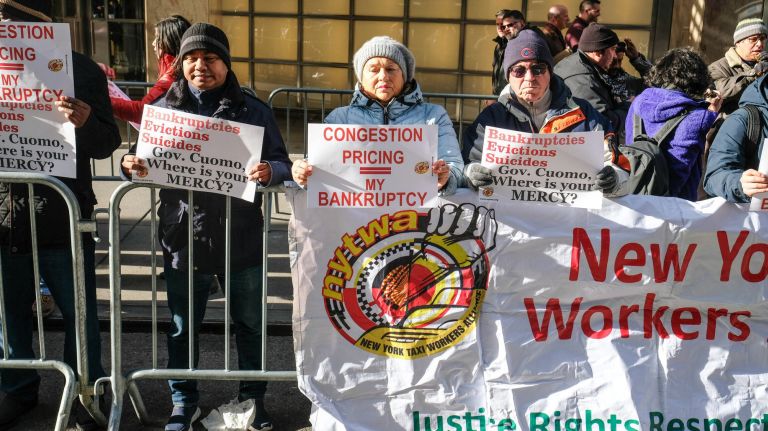 Roughly two dozen yellow and green cab drivers rallied Wednesday outside Gov. Andrew Cuomo's midtown office, calling for the governor to exempt the drivers from a new congestion surcharge that will raise fares for taxi and for-hire vehicle trips occurring in a large swath of Manhattan.