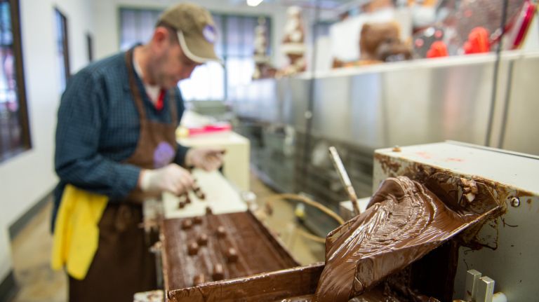 Li-Lac Chocolates celebrates 95 years of handmade tradition 1 Li-Lac Chocolates celebrates 95 years in the chocolate-making business this month. Pictured, a chocolatier makes marzipan rolls on a machine at the front of the store where customers can view through windows.