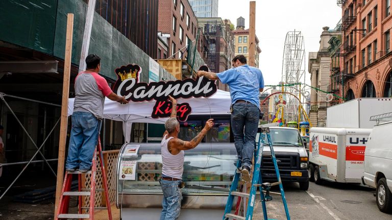 San Gennaro cannoli contest treats come straight from the Cannoli King 2 Workers labor feverishly to complete construction of booths and outdoor cafes before the start of the San Gennaro feast on Mulberry Street in Little Italy, Tuesday.