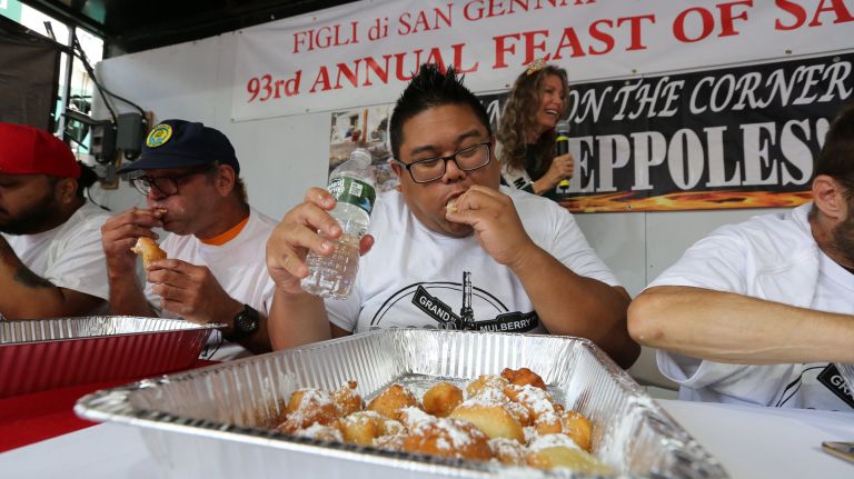 Wayne Algenio, 34, participates in the first zeppole eating contest at the San Gennaro Festival in Little Italy.