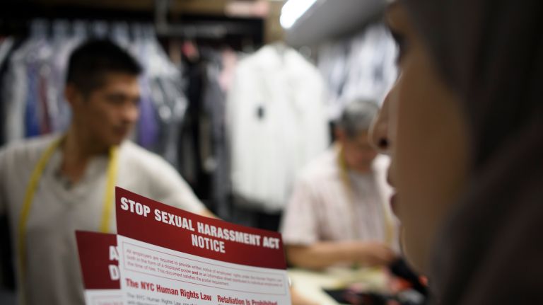 Widad Hassan, right, from the City Commission on Human Rights Community Relation Bureau, distributes anti-sexual harassment notices to Allen Tailor & Cleaning, a business on Allen Street in lower Manhattan on Wednesday.