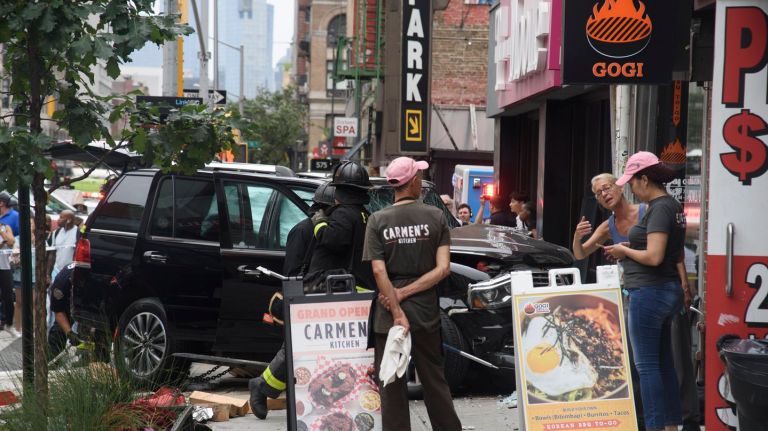 A black SUV crashed into a T-Mobile store and Gogi Grill near the intersection of Sixth Avenue and 17th Street on Monday afternoon.