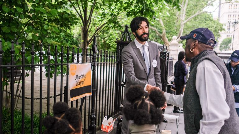 Advocate Alex Low serves as a stand-in for Mayor Bill de Blasio at an event outside City Hall on Sunday calling on the city to fund Fair Fares. 