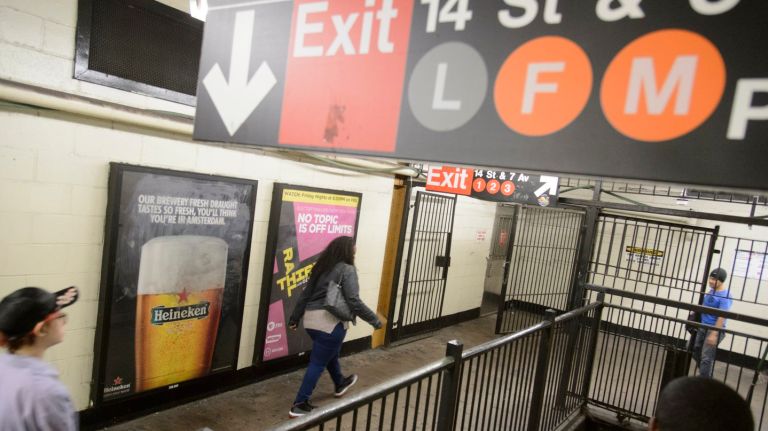 NYC  subway riders make their way through the station at  14th Street in Manhattan.  