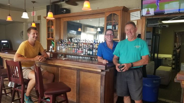Businesses benefit from ferry service, but seek ability to advertise 1 Chadd Kirkland, 35, a Rockaway resident, sits at The Wharf Bar and Grill with Cathy Matthews, a waitress and bartender, and Bob Leckie, right, a co-owner of the venue.