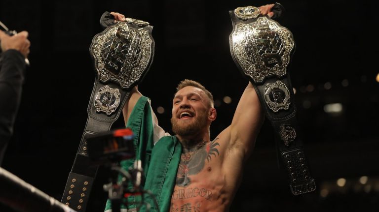 Conor McGregor became the first fighter in UFC history to hold two championships at once with Saturday