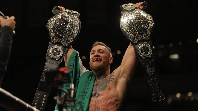 Conor McGregor became the first fighter in UFC history to hold two championships at once with Saturday's victory over lightweight champ Eddie Alvarez at Madison Square Garden.
