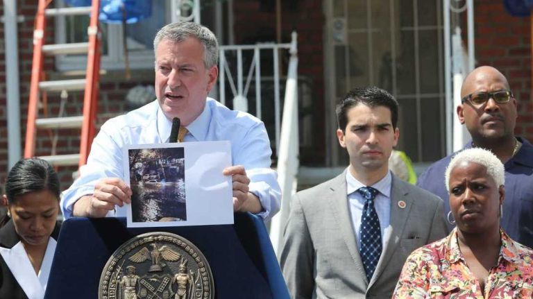 The city's Build it Back program, which reconstructs homes damaged in superstorm Sandy, will not meet its 2016 deadline for completion, Mayor Bill de Blasio said. Above, de Blasio speaks outside of the home of Tonyelle Jobity ( right, front), in Canarsie, Brooklyn, which was being repaired by the program in July 2016.