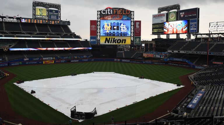 The tarp is on the field at Citi Field because of rain before a game between the New York Mets and the St. Louis Cardinals on Monday, July 25, 2016. The game was postponed for Tuesday, July 26 as part of a single-admission doubleheader.

