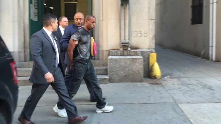 Jermaine Himmelstein is walked from the Midtown North precinct Thursday, May 12, 2016. He was arrested for punching a tourist in Times Square.