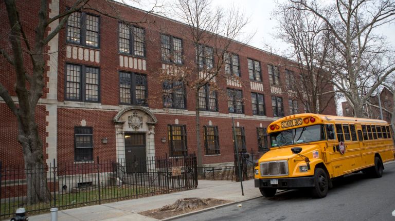 A bus outside PS 12  in Woodside, Queens, where about 100  students came down with an apparent norovirus, on Jan. 14, 2016.