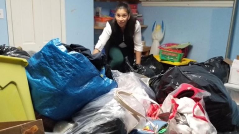 Volunteer Leslie Carrion sorts through donations for fire victim at the Church of the Redeemer in Sunset Park.