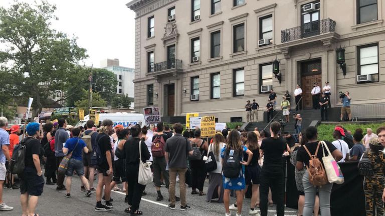Protesters demand the NYPD fire Officer Daniel Pantaleo during a protest outside the 120 Precinct on Wednesday.
