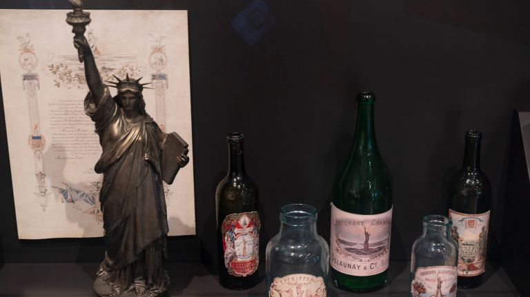 A 22-inch Statue of Liberty figurine and commercial bottles with its likeness are on display at the museum.
