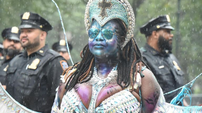 A woman takes part&nbsp;in&nbsp;the West Indian American Day Parade in Crown Heights on Monday, despite the rain.