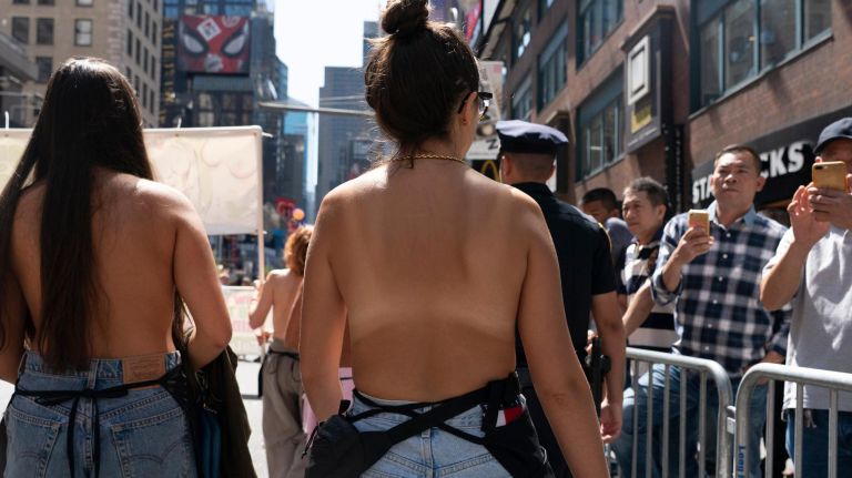 Women march in the parade, which falls before Women's Equality Day, recognizing&nbsp;when women were given the right to vote in the U.S.