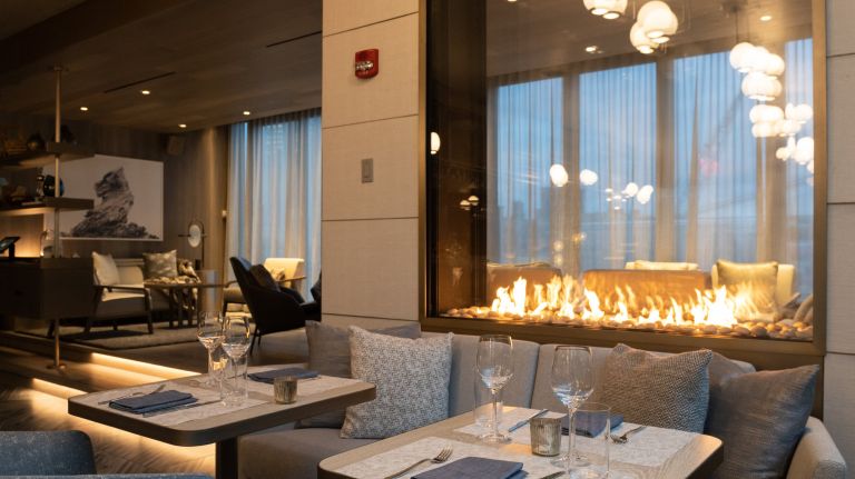 Cozy up next to one of two fireplaces at Pier 17's new rooftop bar, R17.