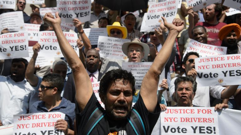 Taxi cab drivers, medallion owners, members of the New York Taxi Workers Alliance and their supporters hold a rally Wednesday on the steps of City Hall before the New York City Council voted on legislation that would regulate the for-hire vehicle industry.