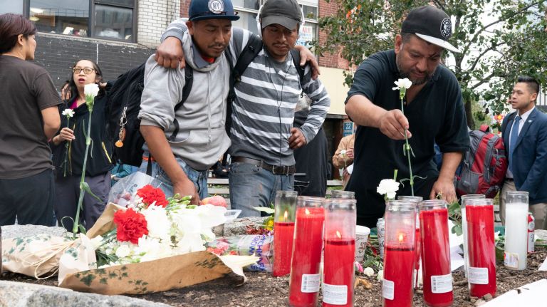 People mourn during a community vigil in Kimlau&nbsp;Square for the four homeless men who were murdered in Chinatown on Saturday. &nbsp;