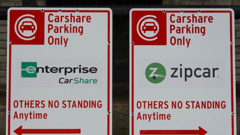 Parking spots dedicated to car-sharing services are a reality 2 Samples of the street signage that will designate new car-share spaces were displayed Thursday.