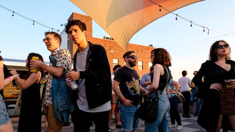 Early arrivals mingle during the opening of the rooftop at Elsewhere music venue on Johnson Avenue in Brooklyn on Friday.