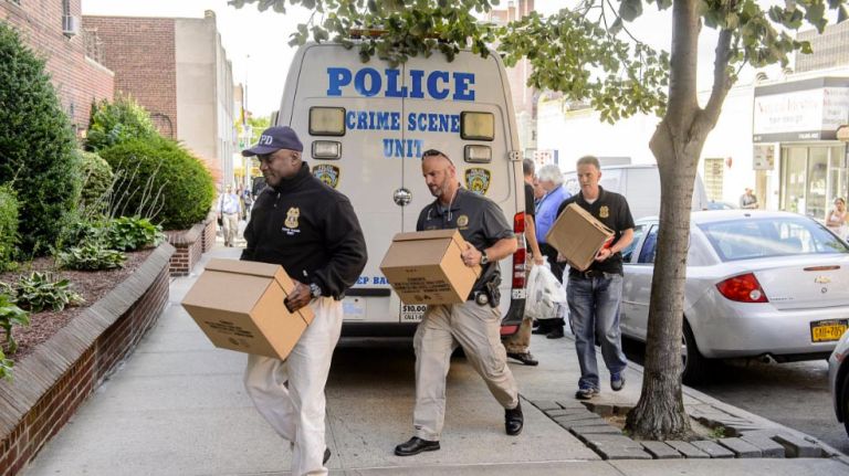 An NYPD sergeant and seven officers were sickened by fumes inside a Rego Park, Queens, apartment building while responding to a call on Friday, Sept. 1, 2017, police said. Above, members of the NYPD Crime Scene Unit arrive to collect evidence from the building on Saunders Street.