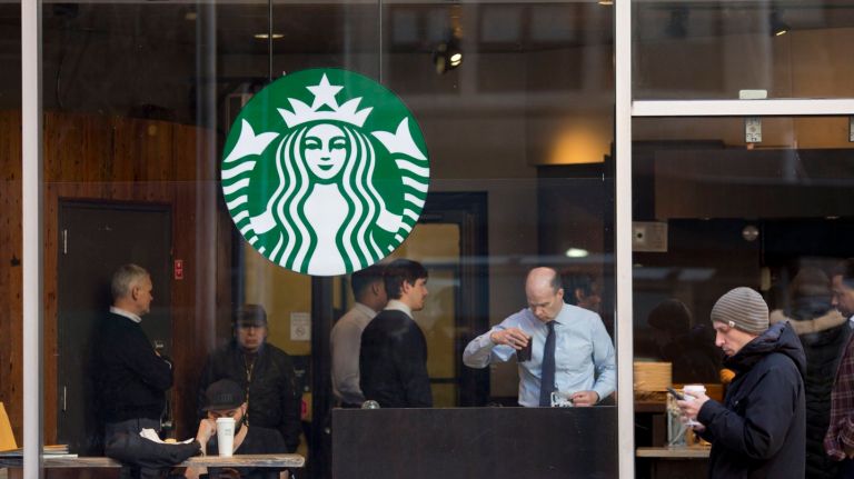 Starbucks received backlash from customers after it said it would hire 10,000 refugees in response to President Donald Trump's immigration travel ban, but New Yorkers are sticking by the chain. Above, the exterior of a Starbucks on  34th Street between Seventh  and  Eighth  avenues  on Jan.  30, 2017.