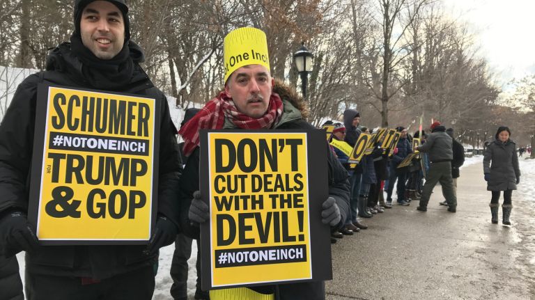 Tim Murphy and a few dozen protesters stood across the street from Sen. Charles Schumer's Park Slope home on Sunday, Jan. 8, 2017, demanding  he defy every measure President-elect Donald Trump proposes.