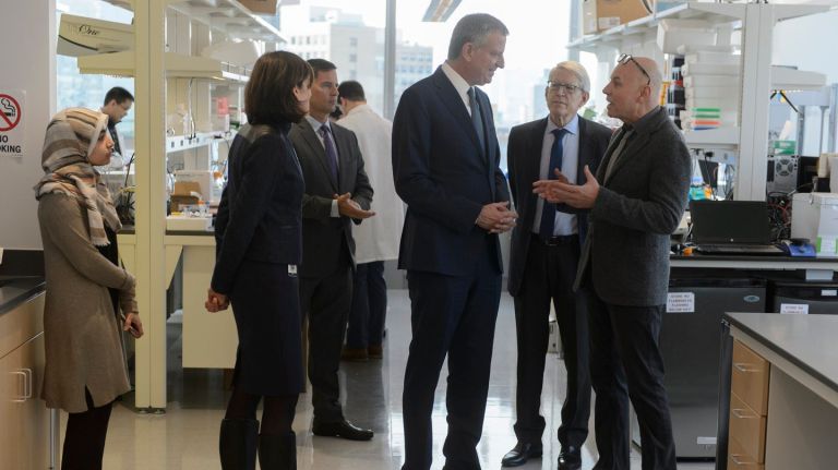 New York City's biotechnology industry will be getting a shot in the arm from Mayor Bill de Blasio's administration via a new $500 million initiative. Above, de Blasio speaks with Kallyope co-founder Charles Zuker, right, during a visit to the company's laboratory in the The Alexandria Center for Life Science in Manhattan on Tuesday, Dec. 13, 2016.
