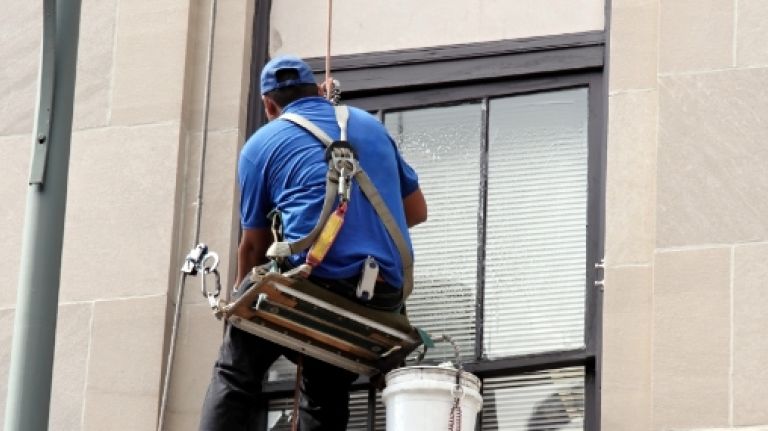 You're not likely to have much luck forcing your landlord to get the building's exterior windows cleaned.