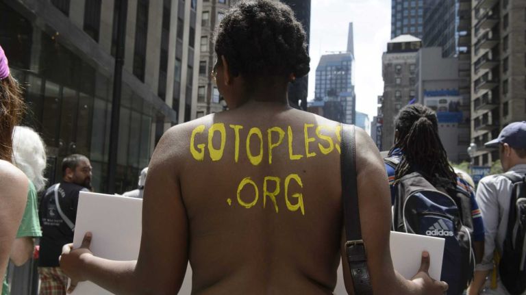 Participants, some topless, march in midtown Manhattan during an event marking International Go Topless Day on Sunday, August 23, 2015. The event was independent of, but coincide with, the apparent proliferation topless tip seeking women in Times Square.