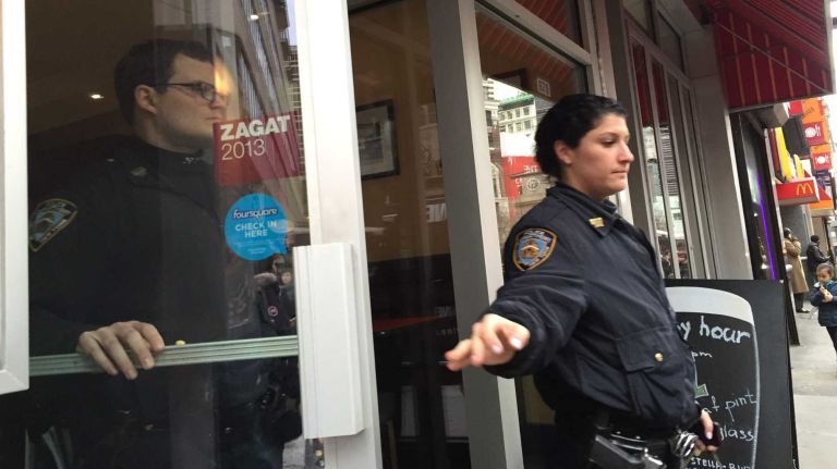 Police investigate the scene after a woman was found with her unconscious one-year-old son in the bathroom of 5 Boro Burger in Midtown on March 30, 2015. The boy died, according to police.