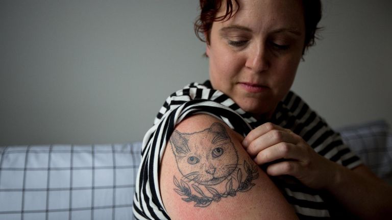 Eleanor Whitney shows a tattoo that she recently got in memory of her cat, Crackers.