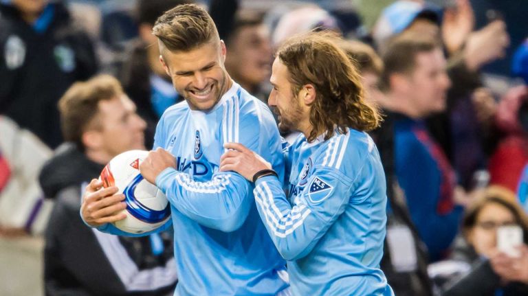 New York City FC defender Chris Wingert (17) celebrates with midfielder Ned Grabavoy (11) after the New York City FC defeated the New England Revolution 2-0 at Yankee Stadium on Sunday, March 15, 2015.