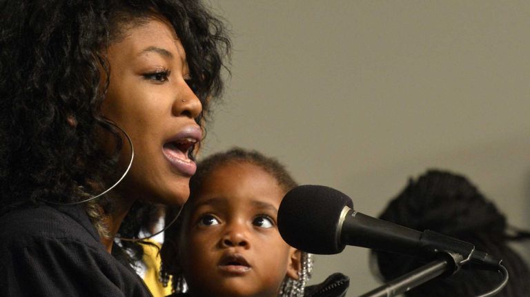 Akisha Pringle (18), sister of Akai Gurley and her niece Akaila Gurley (2), seen onstage at National Action Network headquarters in Harlem on Saturday, Nov. 22, 2014. 