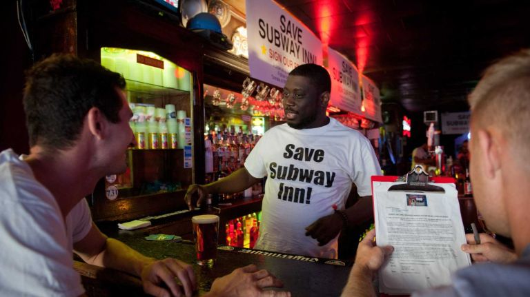 Will Sutton tends bar at the Subway Inn on East 60th Street on Aug. 15, 2014. Patrons and the owners are fighting eviction.