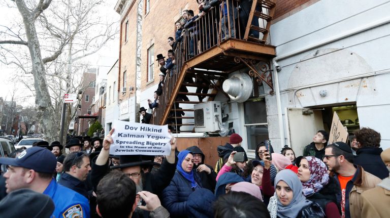 Councilman in anti-Palestine tweet flap could be removed from immigration committee 3 Local residents watch as protestors rally outside Councilman Kalman Yeger's Brooklyn office over an anti-Palestine tweet on Thursday.
