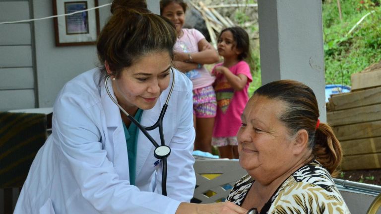 A SOMOS physician evaluates a patient in Puerto Rico in 2018 during a humanitarian aid mission following&nbsp;Hurricane Maria.