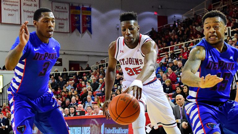 St. John's center Yankuba Sima (35) attempts to control a loose ball under pressure from DePaul forward Rashaun Stimage (3) and guard Aaron Simpson (15) at Carnesecca Arena in Queens, New York on Wednesday, Feb 17, 2016. 