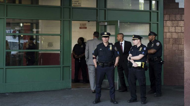 NYPD officers outside 2000 Valentine Ave. in the Bronx where a man, 19, who assaulted a woman with a gun inside a fourth-floor apartment,  was shot by responding officers after he pointed the gun at them on Wednesday, June 10, 2015.