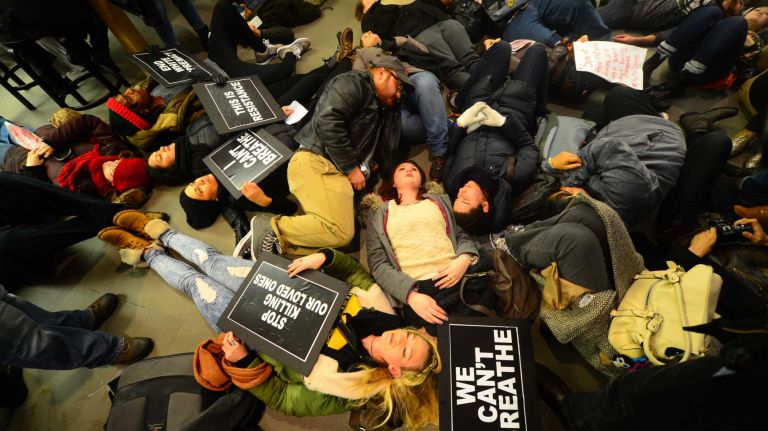 Protesters rallying against a grand jury's decision not to indict the police officer involved in the death of Eric Garner stage a 