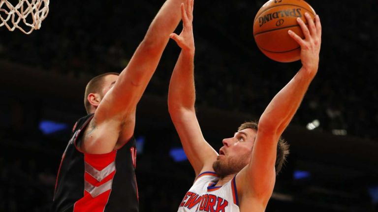 Beno Udrih of the Knicks goes to the hoop against Jonas Valanciunas of the Toronto Raptors at Madison Square Garden on Dec. 27, 2013.