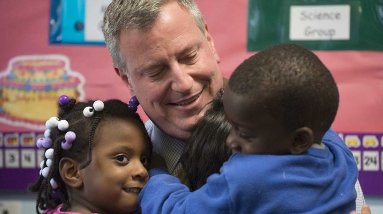 Bill de Blasio's faulty way to pre-K 1 New York City Mayor Bill de Blasio receives hugs after reading 'My Family Is Forever' by Nancy Carlson, to Pre-K children at the Children's Aid Society's East Harlem Cente in Manhattan. (Sept. 30, 2013)