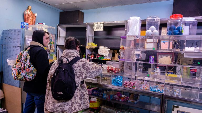 Customers&nbsp;at Raul's Candy Store purchase some of the last remaining goods.
