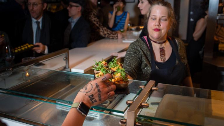 Sous&nbsp;chef Kim Hafner serves hors d'oeuvres.