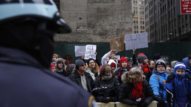 NYPD officers form a barrier between demonstrators at the Macy's Thanksgiving Day Parade at 37th Street and Avenue of the Americas in Manhattan. They were protesting a grand jury decision on Nov. 24, 2014 not to indict a Ferguson, Mo., police officer Darren Wilson in the death on Aug. 9 of Michael Brown, an unarmed black teen.